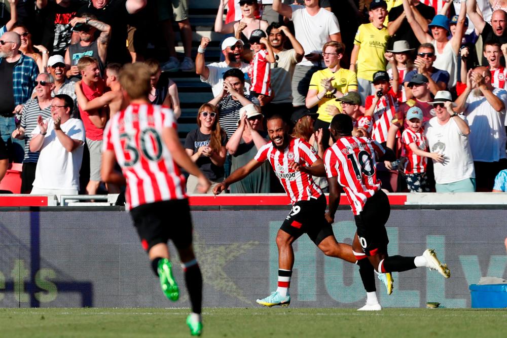 Brentford’s French midfielder Bryan Mbeumo (C) celebrates with teammates after scoring their fourth goal during the English Premier League football match between Brentford and Manchester United at Brentford Community Stadium in London on August 13, 2022. AFPPIX