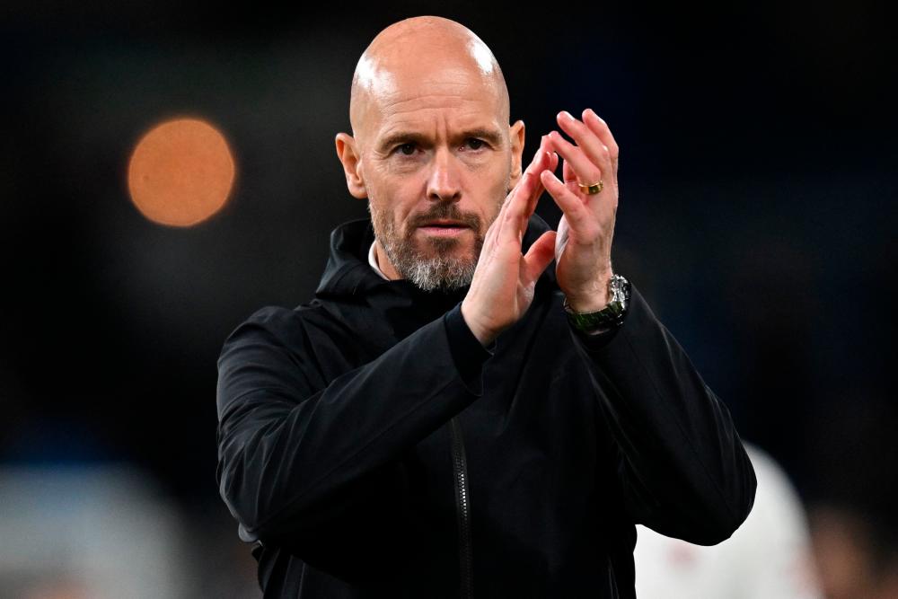 Manchester United's Dutch manager Erik ten Hag applauds fans on the pitch after the English Premier League football match between Burnley and Manchester United at Turf Moor in Burnley, north-west England on September 23, 2023. - AFPPIX