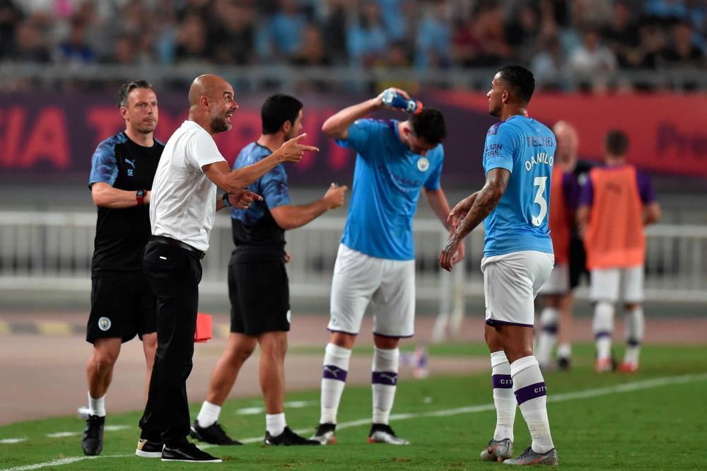 Manchester City’s coach Pep Guardiola (2L) gives intructions to player Danilo during the semifinals matches of the 2019 Premier League Asia Trophy Football tournament in Nanjing, in Jiangsu province on July 17, 2019. — AFP