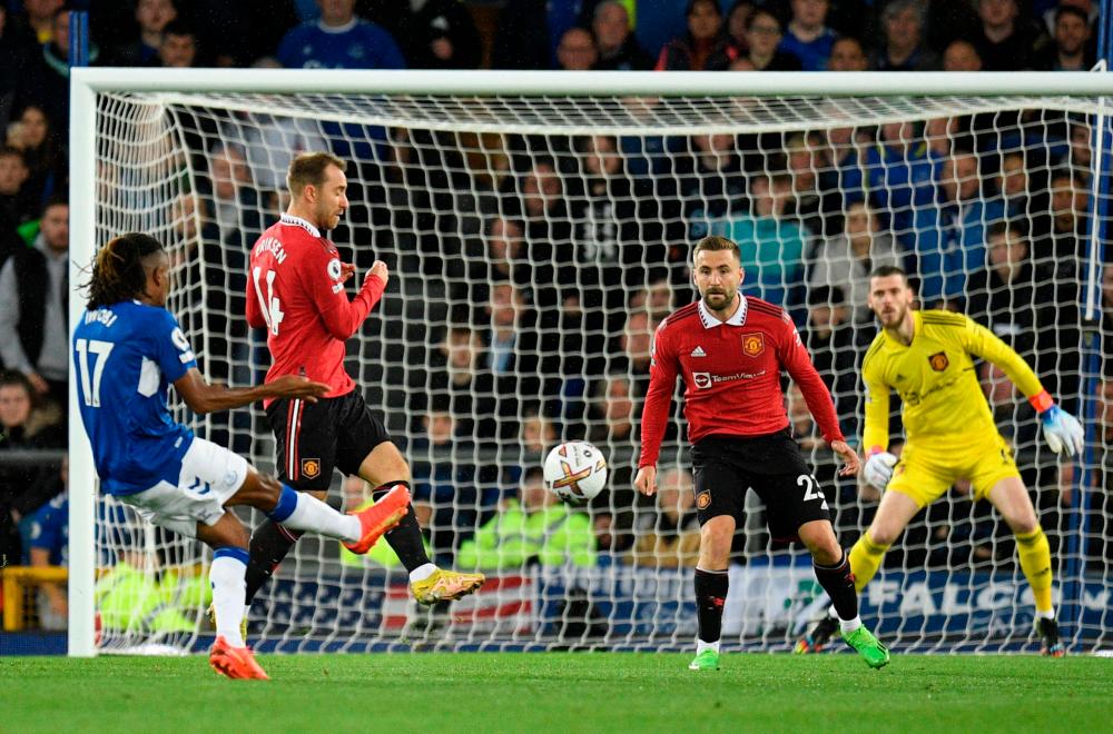 Everton’s Nigerian midfielder Alex Iwobi (L) scores his team’s first goal during the English Premier League football match between Everton and Manchester United at Goodison Park in Liverpool, north west England on October 9, 2022. AFPPIX