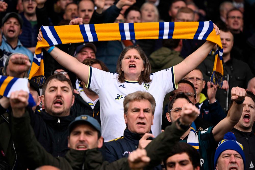 A Leeds fan holds up a scarf in the crowd ahead of the English Premier League football match between Leeds United and Manchester United at Elland Road in Leeds, northern England on February 12, 2023. AFPPIX