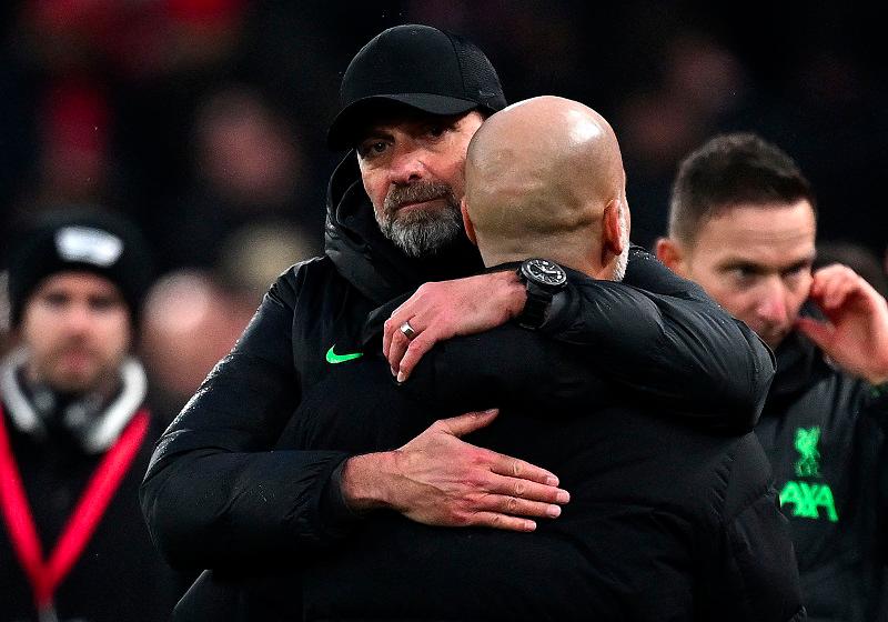 $!Liverpool's German manager Jurgen Klopp embraces Manchester City's Spanish manager Pep Guardiola at the end of the English Premier League football match between Liverpool and Manchester City at Anfield in Liverpool, north west England on March 10, 2024. The Match ended in a draw at 1-1. -AFP pix