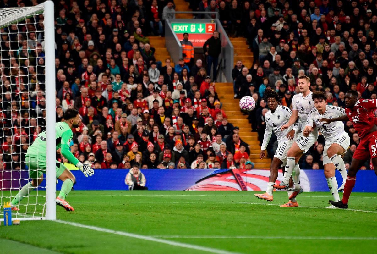 Manchester United’s English defender #05 Harry Maguire scores the team’s second goal during the English Premier League football match between Liverpool and Manchester United at Anfield in Liverpool. - PETER POWELL / AFP