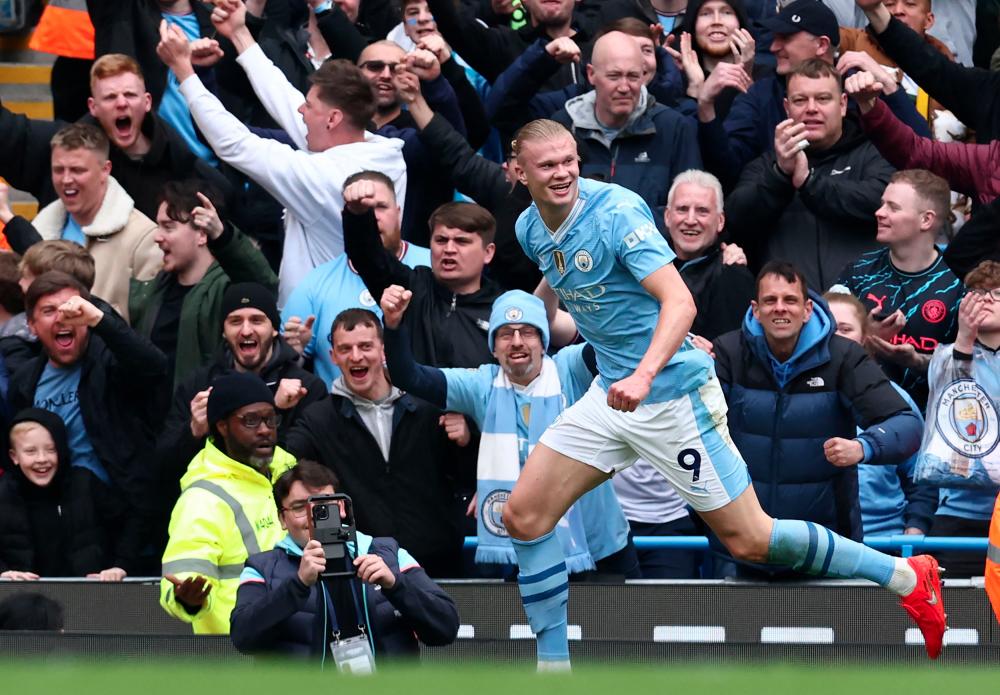 Manchester City's Norwegian striker #09 Erling Haaland celebrates after scoring their second goal during the English Premier League football match between Manchester City and Wolverhampton Wanderers at the Etihad Stadium in Manchester, north west England, on May 4, 2024. - AFPPIX