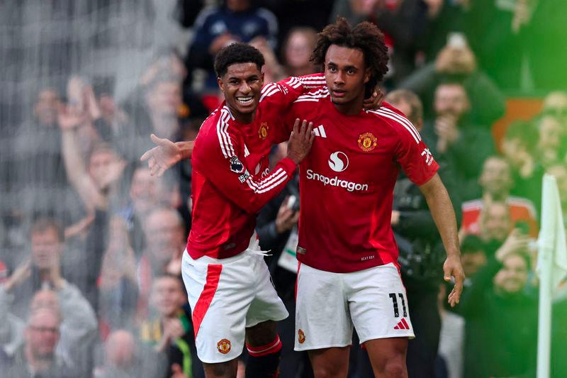 Manchester United's Dutch striker #11 Joshua Zirkzee (R) celebrates with Manchester United's English striker #10 Marcus Rashford (L) after scoring their second goal during the English Premier League football match between Manchester United and Everton at Old Trafford in Manchester, north west England, on December 1, 2024. - AFPPIX