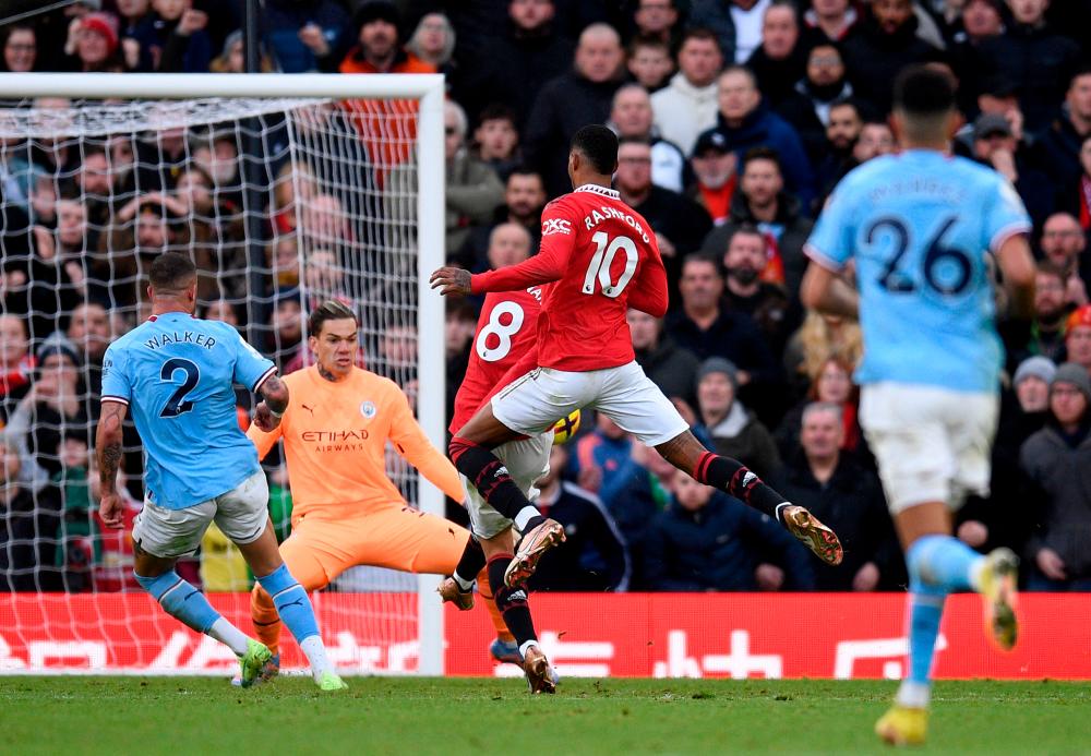 Manchester United’s English striker Marcus Rashford (R) watches as Manchester United’s Portuguese midfielder Bruno Fernandes (C) scores the equalising goal past Manchester City’s Brazilian goalkeeper Ederson during the English Premier League football match between Manchester United and Manchester City at Old Trafford in Manchester, north west England, on January 14, 2023. AFPPIX