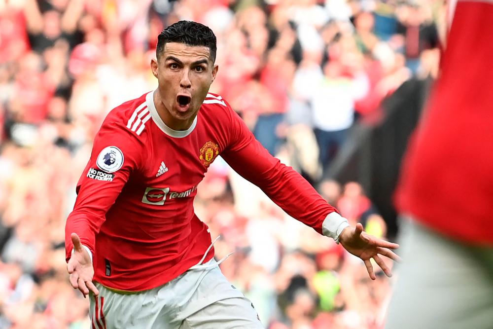Manchester United’s Portuguese striker Cristiano Ronaldo celebrates after scoring his third goal during the English Premier League football match between Manchester United and Norwich City at Old Trafford in Manchester, north west England, on April 16, 2022. AFPPIX