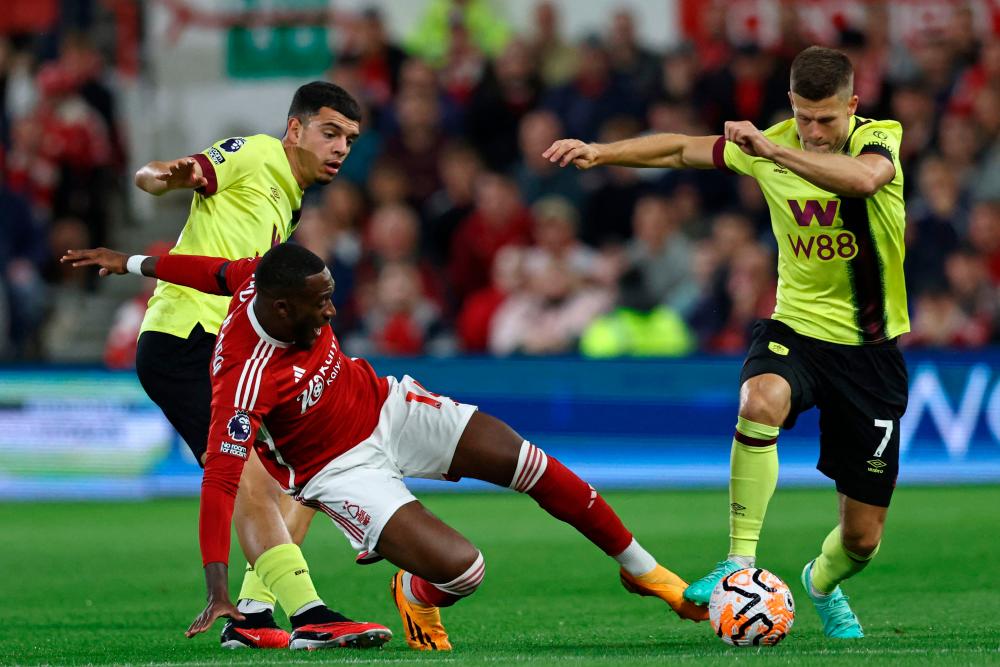 Callum Hudson-Odoi (C) vies with Zeki Amdouni (L) and Berg Gudmundsson (R) during the English Premier League football match between Nottingham Forest and Burnley at The City Ground in Nottingham, central England, on September 18, 2023. AFPPIX