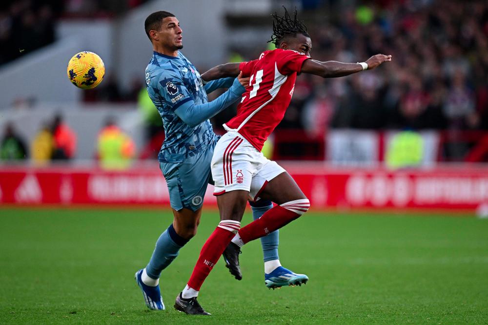 Aston Villa's Brazilian defender #03 Diego Carlos (L) clashes with Nottingham Forest's Swedish midfielder #21 Anthony Elanga during the English Premier League football match between Nottingham Forest and Aston Villa at The City Ground in Nottingham, central England, on November 5, 2023. - AFPPIX