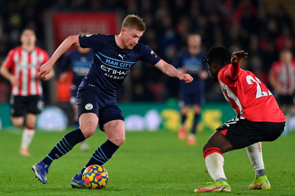 Manchester City’s Belgian midfielder Kevin De Bruyne (L) vies with Southampton’s Ghanaian defender Mohammed Salisu (R) during the English Premier League football match between Southampton and Manchester City at St Mary’s Stadium in Southampton, southern England on January 22, 2022. AFPPIX