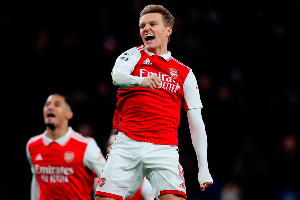 Filepix: Arsenal’s Norwegian midfielder Martin Odegaard (C) celebrates with teammates on the pitch after the English Premier League football match between Tottenham Hotspur and Arsenal/AFPPIX