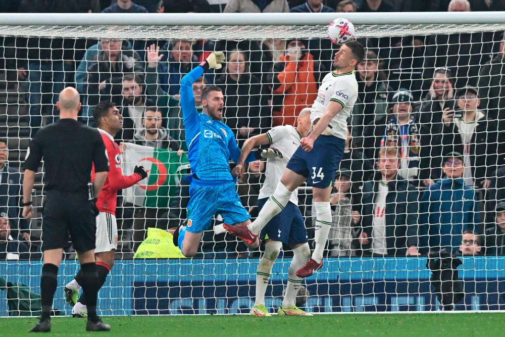 Clement Lenglet (R) jumps for the ball in the Manchester United goalmouth during the English Premier League football match between Tottenham Hotspur and Manchester United at Tottenham Hotspur Stadium in London, on April 27, 2023. AFPPIX