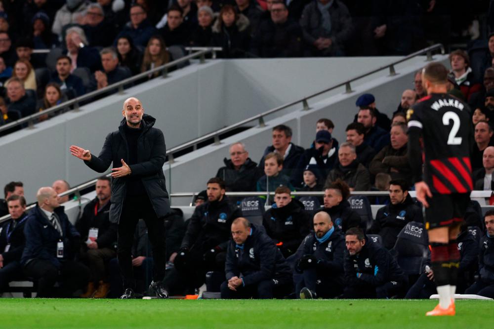 Manchester City’s Spanish manager Pep Guardiola (L) gives indications from the touch line during the English Premier League football match between Tottenham Hotspur and Manchester City at Tottenham Hotspur Stadium in London, on February 5, 2023/AFPPix