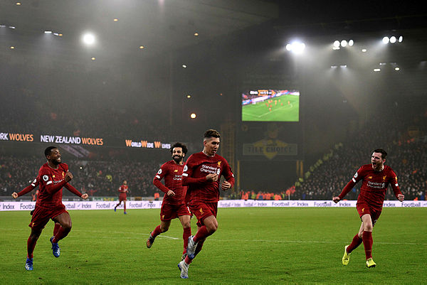 Liverpool’s Brazilian midfielder Roberto Firmino (2R) celebrates with teammates after he scores the team’s second goal during the English Premier League football match between Wolverhampton Wanderers and Liverpool at the Molineux stadium in Wolverhampton, central England on Jan 23.