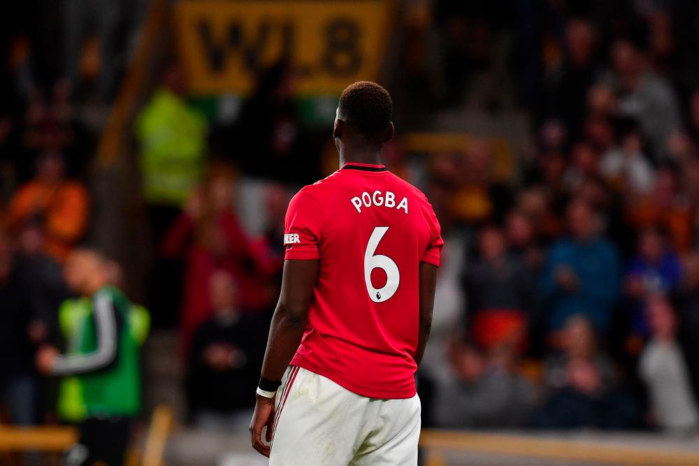 Manchester United’s French midfielder Paul Pogba reacts after his penalty shot was saved during the English Premier League football match between Wolverhampton Wanderers and Manchester United at the Molineux stadium in Wolverhampton, central England on August 19, 2019. — AFP