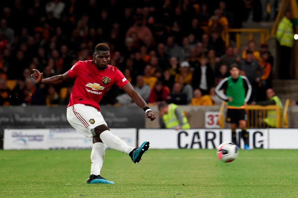 Manchester United’s French midfielder Paul Pogba shoots from the penalty spot but fails to score during the English Premier League football match between Wolverhampton Wanderers and Manchester United at the Molineux stadium in Wolverhampton, central England on August 19, 2019. — AFP