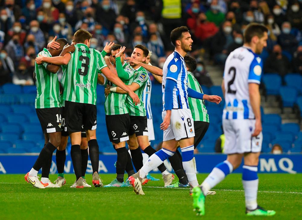 Real Betis’ Spanish forward Juanmi (2ndR) celebrates with teammates after scoring his team’s first goal during the Spanish Copa del Rey (King’s Cup) quarter-final football match between Real Sociedad and Real Betis at the Anoeta stadium in San Sebastian on February 3, 2022 AFPPIX