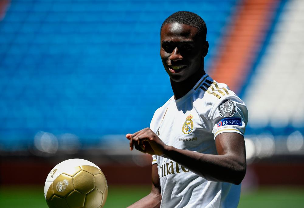 French defender Ferland Mendy plays with a ball during his official presentation as Real Madrid as new player of the Spanish club at the Santiago Bernabeu stadium in Madrid on June 19, 2019. — AFP