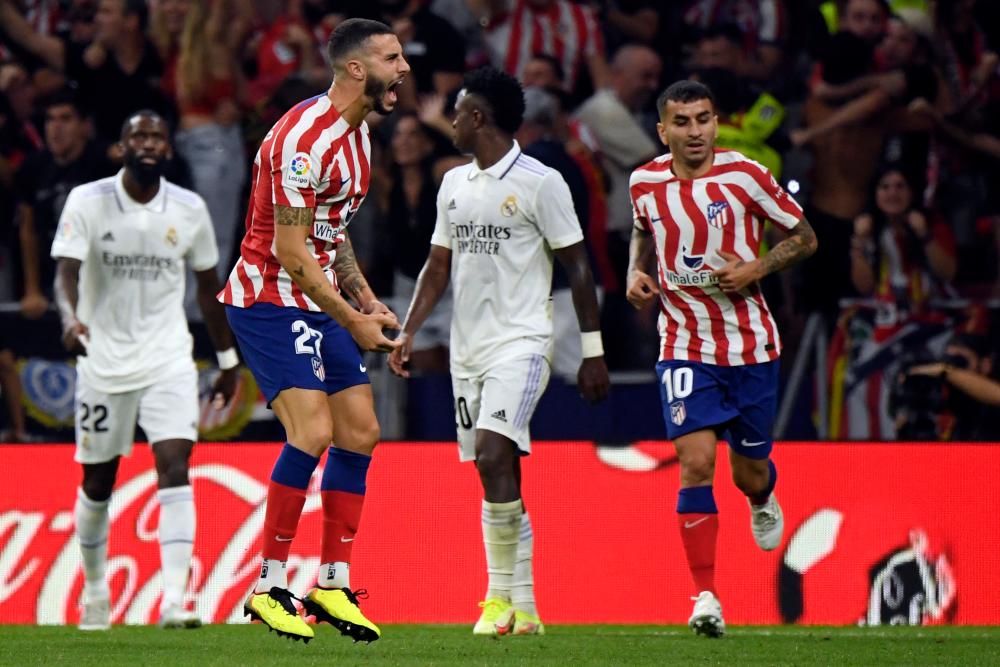 Atletico Madrid’s Spanish defender Mario Hermoso (L) celebrates after scoring during the Spanish League football match between Club Atletico de Madrid and Real Madrid CF at the Wanda Metropolitano stadium in Madrid/AFPPix