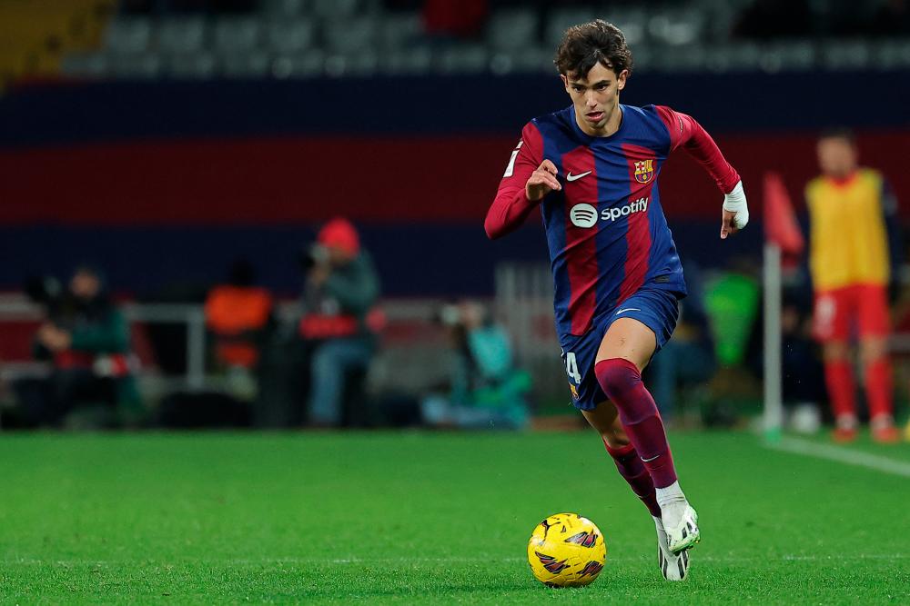Barcelona’s Portuguese forward #14 Joao Felix dribbles the ball during the Spanish league football match between FC Barcelona and Club Atletico de Madrid at the Estadi Olimpic Lluis Companys in Barcelona on December 3, 2023/AFPPix