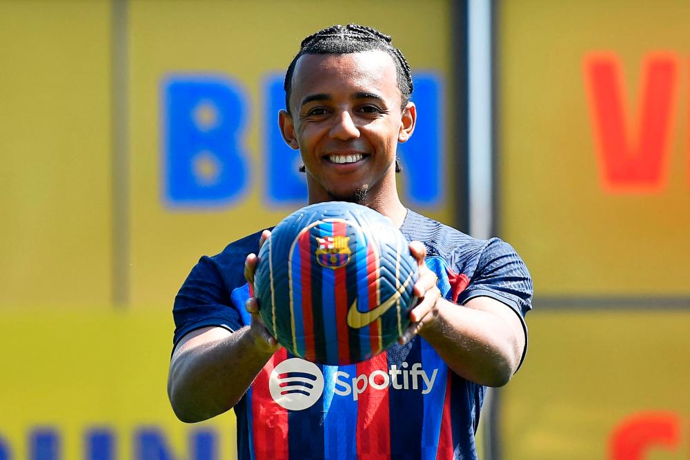 FC Barcelona’s new french defender Jules Kounde poses for pictures during his presentation ceremony at the Joan Gamper training ground in Sant Joan Despi, near Barcelona, on August 1, 2022. AFPPIX
