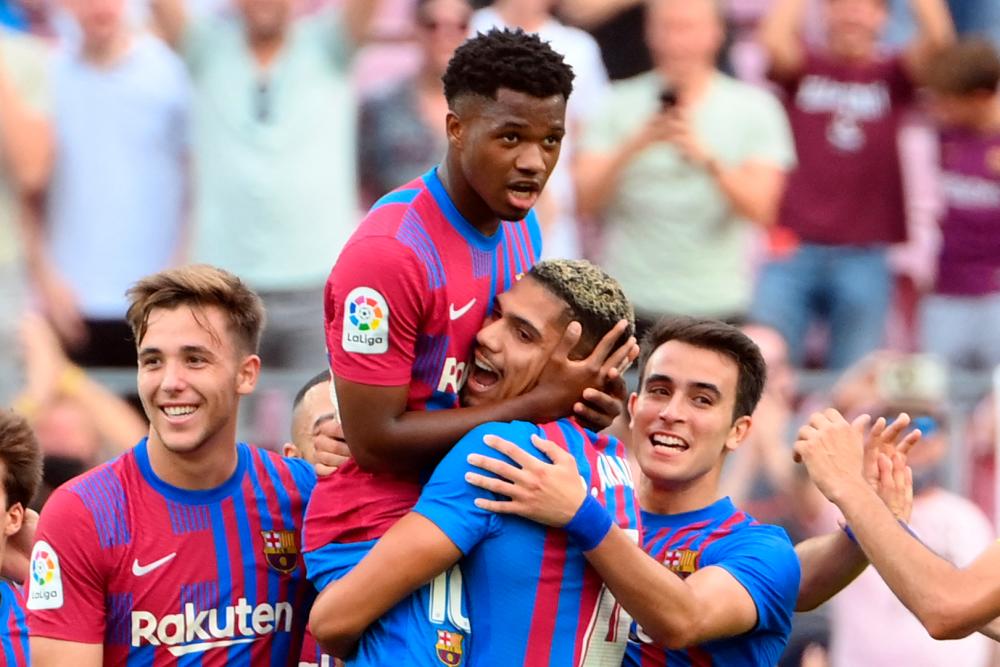 Ansu Fati (2nd right) celebrates scoring his team’s third goal during the Spanish League football match against Levante UD at the Camp Nou stadium in Barcelona. – AFPPIX