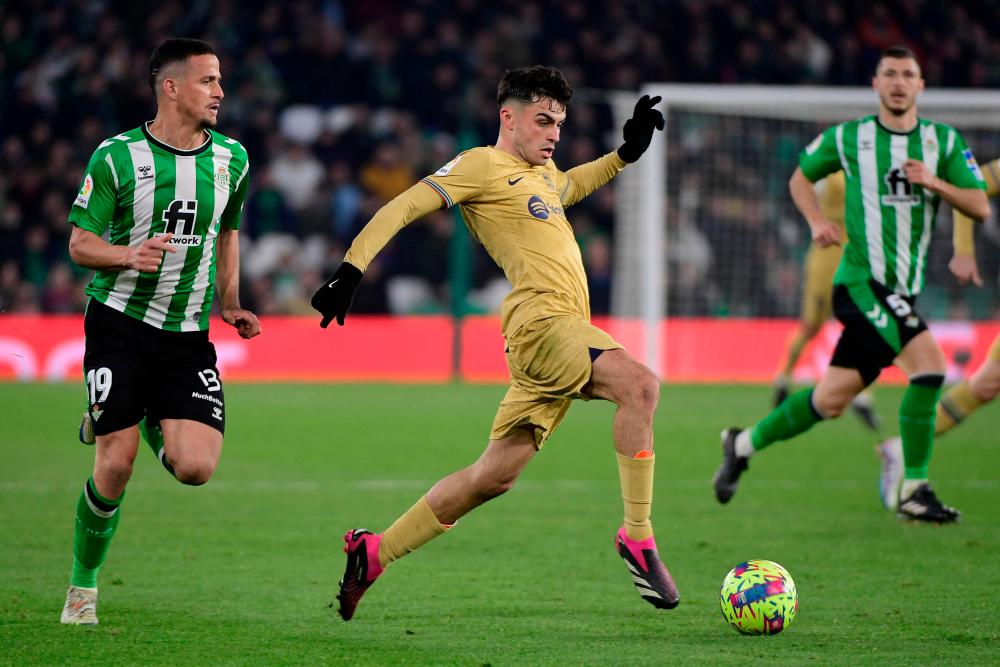 Real Betis’ Italian defender Luiz Felipe (L) fights for the ball with Barcelona’s Spanish midfielder Pedri during the Spanish league football match between Real Betis and FC Barcelona at the Benito Villamarin stadium in Seville on February 1, 2023/AFPPix