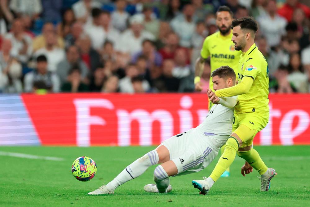 Federico Valverde (L) vies with Alex Baena during the Spanish league football match between Real Madrid CF and Villarreal CF at the Santiago Bernabeu stadium in Madrid on April 8, 2023. AFPPIX