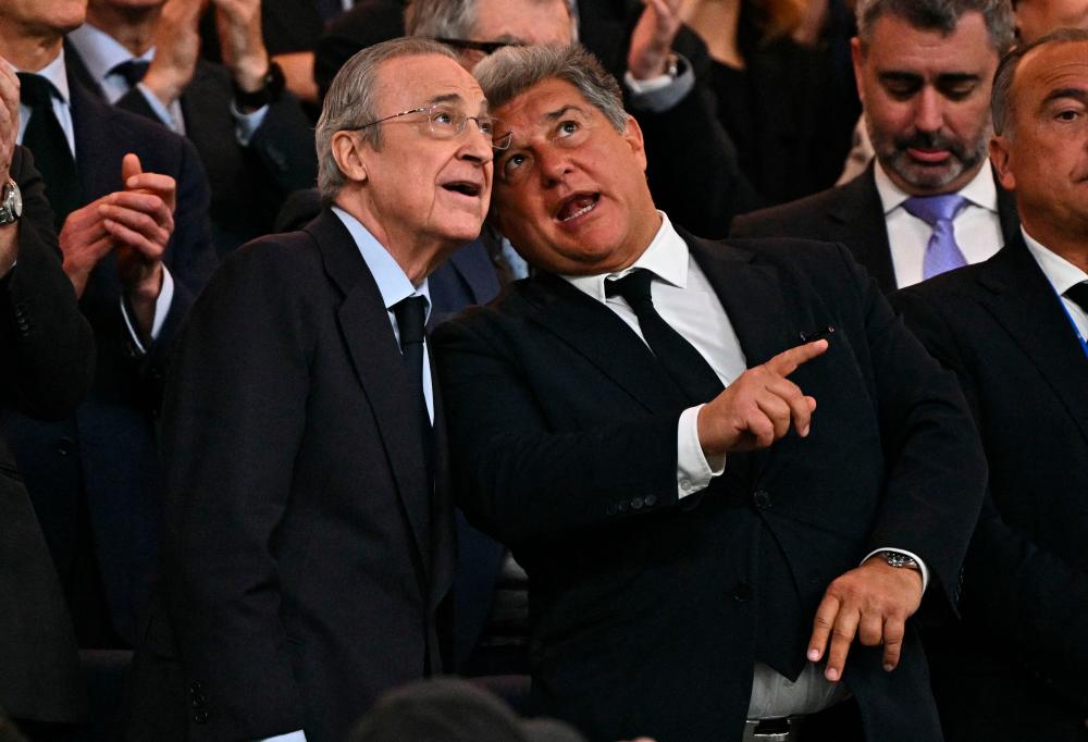 Real Madrid’s president Florentino Perez and Barcelona’s president Joan Laporta (C,R) talks during the Spanish league football match between Real Madrid CF and FC Barcelona at the Santiago Bernabeu stadium in Madrid on April 21, 2024/AFPPix