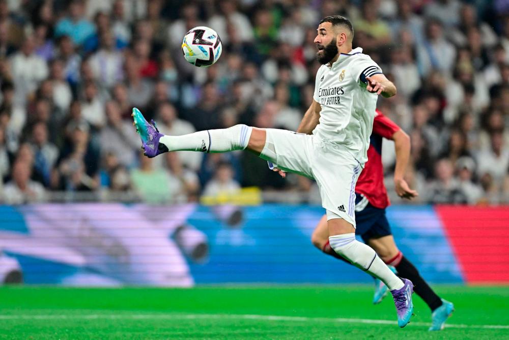 Real Madrid's French forward Karim Benzema controls the ball during the Spanish League football match between Real Madrid CF and CA Osasuna at the Santiago Bernabeu stadium in Madrid on October 2, 2022. - AFPPIX