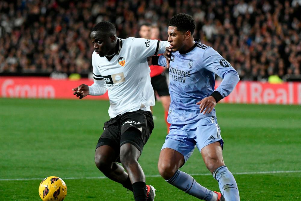 Valencia’s Guinean defender #04 Mouctar Diakhaby vies with Real Madrid’s English midfielder #5 Jude Bellingham during the Spanish league football match between Valencia CF and Real Madrid at the Mestalla stadium in Valencia on March 2, 2024/AFPPix