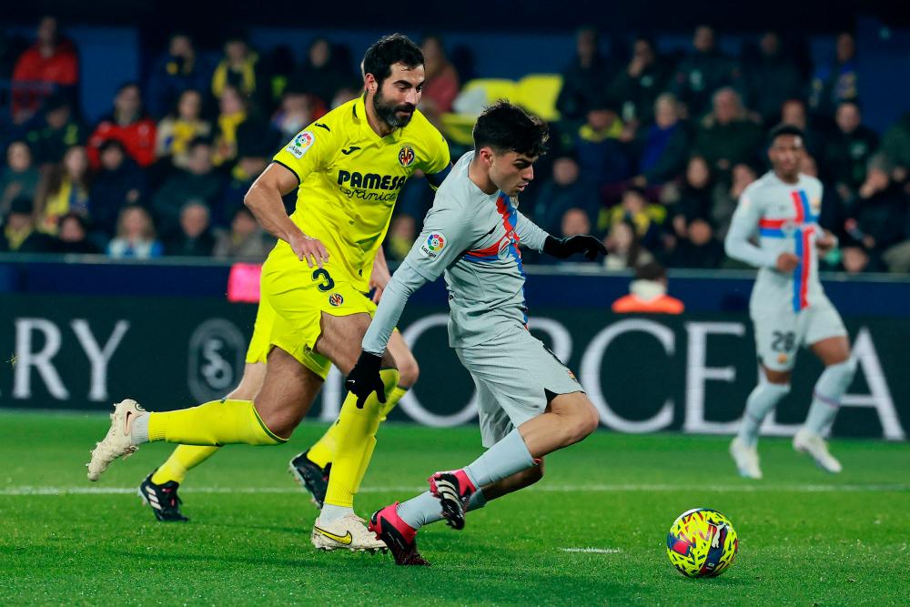 Barcelona beats Villarreal 1-0 to go 11 points clear of Real Madrid at the  top of La Liga