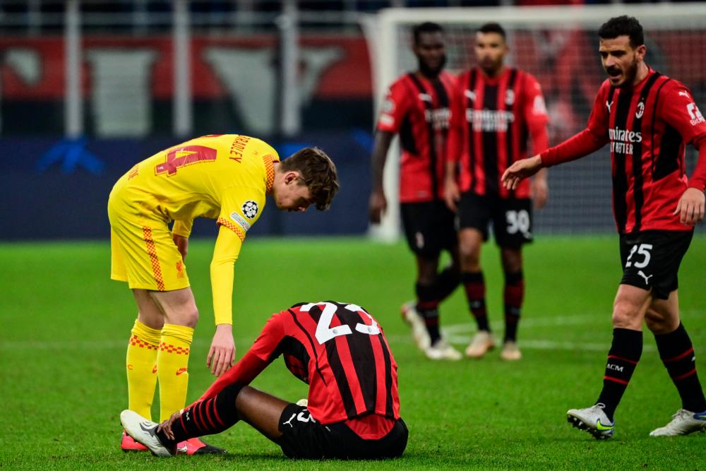 Liverpool's British midfielder Conor Bradley (L) comforts AC Milan's English defender Fikayo Tomori at the end of the UEFA Champions League Group B football match between AC Milan and Liverpool on December 7, 2021 at the San Siro stadium in Milan. AFPpix
