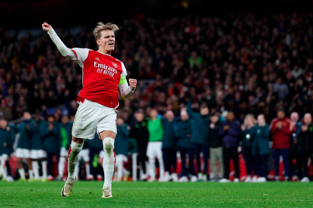 Arsenal’s Norwegian midfielder #08 Martin Odegaard reacts after scoring during the penalty shoot-out of the UEFA Champions League last 16 second leg football match between Arsenal and Porto FC at the Arsenal Stadium in north London, on March 12, 2024/AFPPix