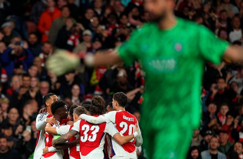 Arsenal’s midfielder Bukayo Saka is mobbed by teammates after scoring the team’s second goal - AFPpix