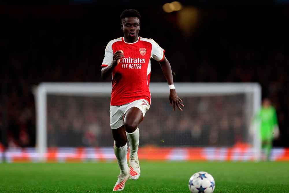 Arsenal’s English midfielder #07 Bukayo Saka runs with the ball to score his team’s second goal during the UEFA Champions League Group B football match between Arsenal and Sevilla at the Emirates Stadium in north London on November 8, 2023/AFPPix