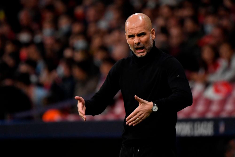 Manchester City's Spanish coach Josep Guardiola gestures during the UEFA Champions League quarter final second leg football match between Club Atletico de Madrid and Manchester City FC at the Wanda Metropolitano stadium in Madrid on April 13, 2022. AFPPIX