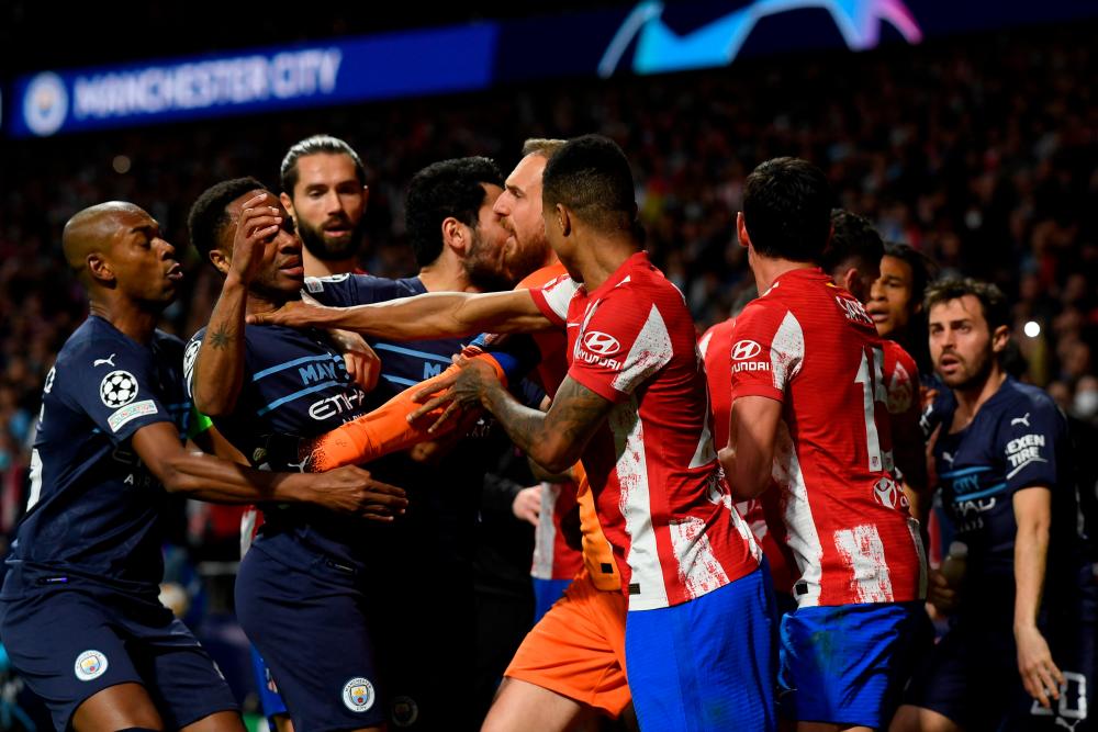 Players fight during the UEFA Champions League quarter final second leg football match between Club Atletico de Madrid and Manchester City FC at the Wanda Metropolitano stadium in Madrid on April 13, 2022. AFPPIX