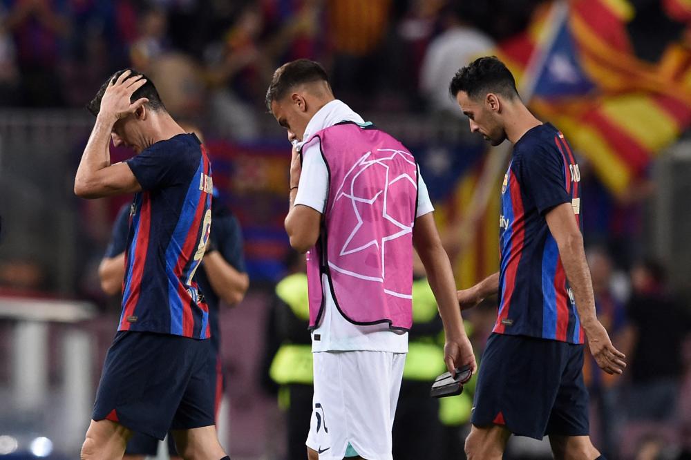 Barcelona’s Polish forward Robert Lewandowski (L) reacts at the end of the UEFA Champions League 1st round, group C, football match between FC Barcelona and Inter Milan at the Camp Nou stadium in Barcelona on October 12, 2022. AFPPIX
