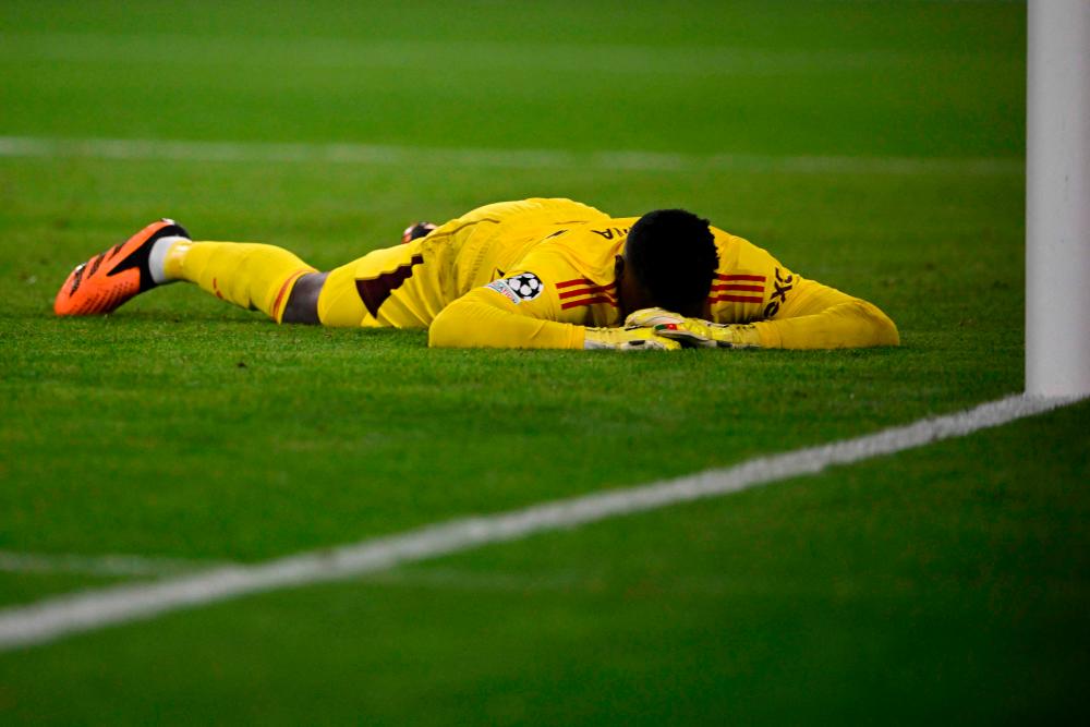 Andre Onana reacts after conceding the opening goal during the UEFA Champions League Group A football match FC Bayern Munich v Manchester United in Munich, southern Germany on September 20, 2023. AFPPIX