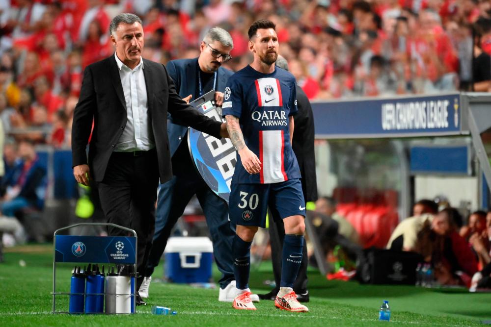 Paris Saint-Germain’s French head coach Christophe Galtier (L) walks with Paris Saint-Germain’s Argentine forward Lionel Messi as he leaves the pitch during the UEFA Champions League 1st round day 3 group H football match between SL Benfica and Paris Saint-Germain, at the Luz stadium in Lisbon on October 5, 2022. AFPPIX