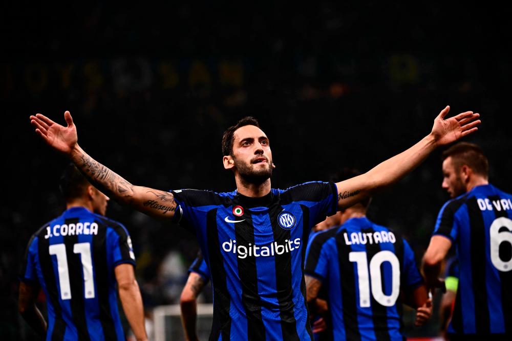 Inter Milan’s Turkish midfielder Hakan Calhanoglu celebrates after opening the scoring during the UEFA Champions League Group C football match between Inter Milan and FC Barcelona on October 4, 2022 at the Giuseppe-Meazza (San Siro) stadium in Milan. AFPPIX
