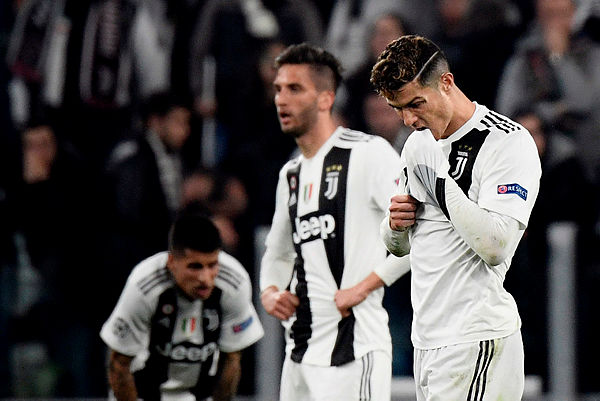 Juventus’ Portuguese forward Cristiano Ronaldo (R) reacts at the end of the UEFA Champions League quarter-final second leg football match Juventus vs Ajax Amsterdam on April 16, 2019 at the Juventus stadium in Turin. — AFP