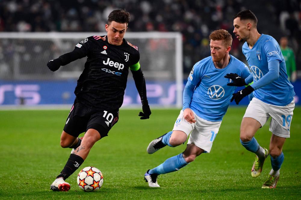 Juventus' Argentine forward Paulo Dybala (L) challenges Malmo's Dannish midfielder Anders Christiansen (C) and Malmo's Serbian midfielder Veljko Birmancevic during the UEFA Champions League Group H football match between Juventus and Malmo on December 8, 2021 at the Juventus stadium in Turin. AFPpix