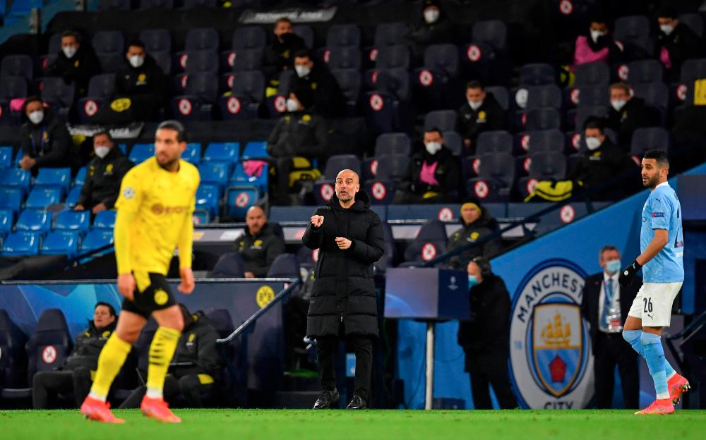 Man City’s manager Pep Guardiola (centre) shouts instructions to his players from the touchline during the UEFA Champions League first leg quarterfinal match against Borussia Dortmund at the Etihad Stadium. – REUTERSPIX