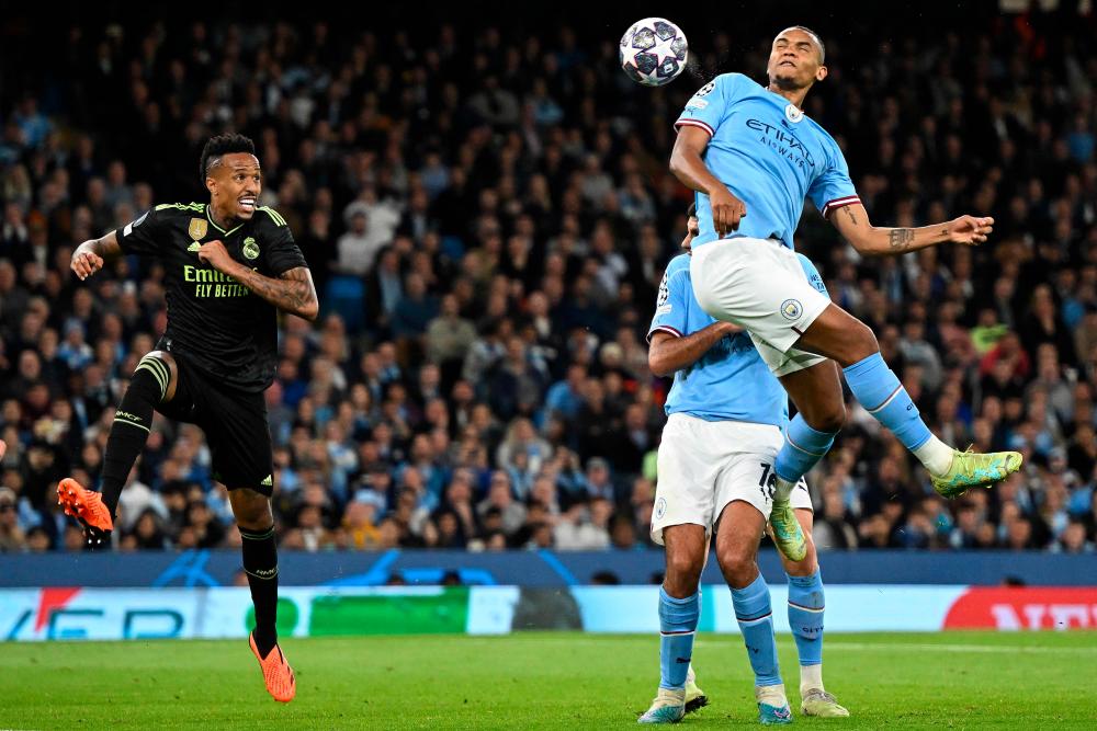 Manchester City’s Manuel Akanji (R) headers past Real Madrid’s Eder Militao to scores the team’s third goal during the UEFA Champions League second leg semi-final football match between Manchester City and Real Madrid at the Etihad Stadium in Manchester, north west England, on May 17, 2023/AFPPix