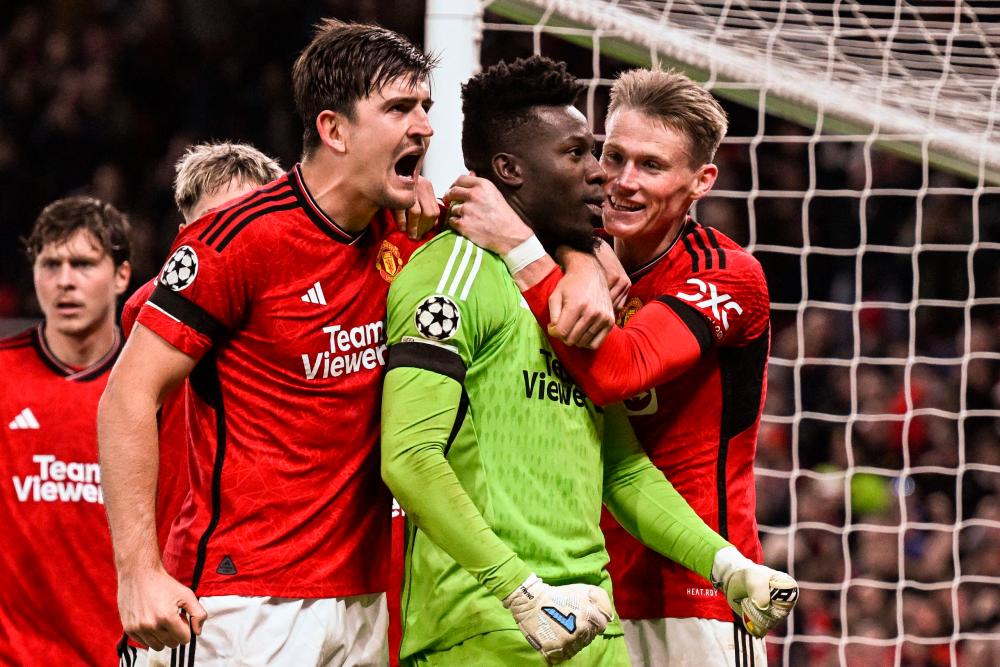Andre Onana (R) celebrates with Harry Maguire and teammates after saving a penalty kick at the end of the UEFA Champions League Group A football match between Manchester United and FC Copenhagen at Old Trafford, in Manchester, north-west England, on October 24, 2023. AFPPIX