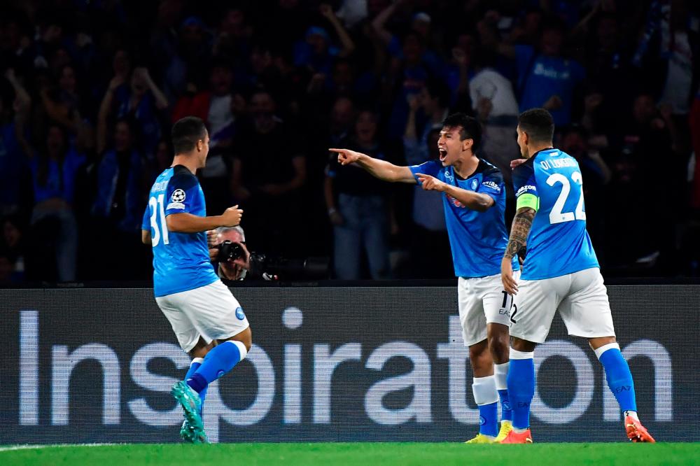 Napoli's Mexican forward Hirving Lozano (C) celebrates scoring his team's first goal during the UEFA Champions League Group A football match between SSC Napoli and Ajax Amsterdam at the Diego Armando Maradona Stadium in Naples on October 12, 2022. AFPPIX