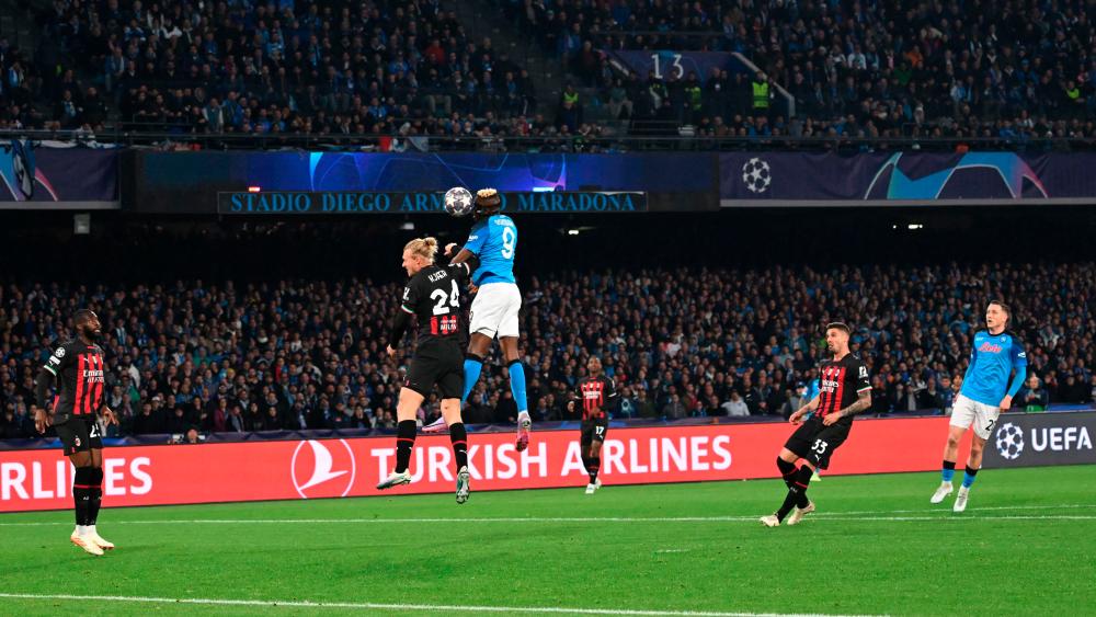 Victor Osimhen (C) and Simon Kjaer go for a header during the UEFA Champions League quarter-finals second leg football match between SSC Napoli and AC Milan on April 18, 2023 at the Diego-Maradona stadium in Naples. AFPPIX