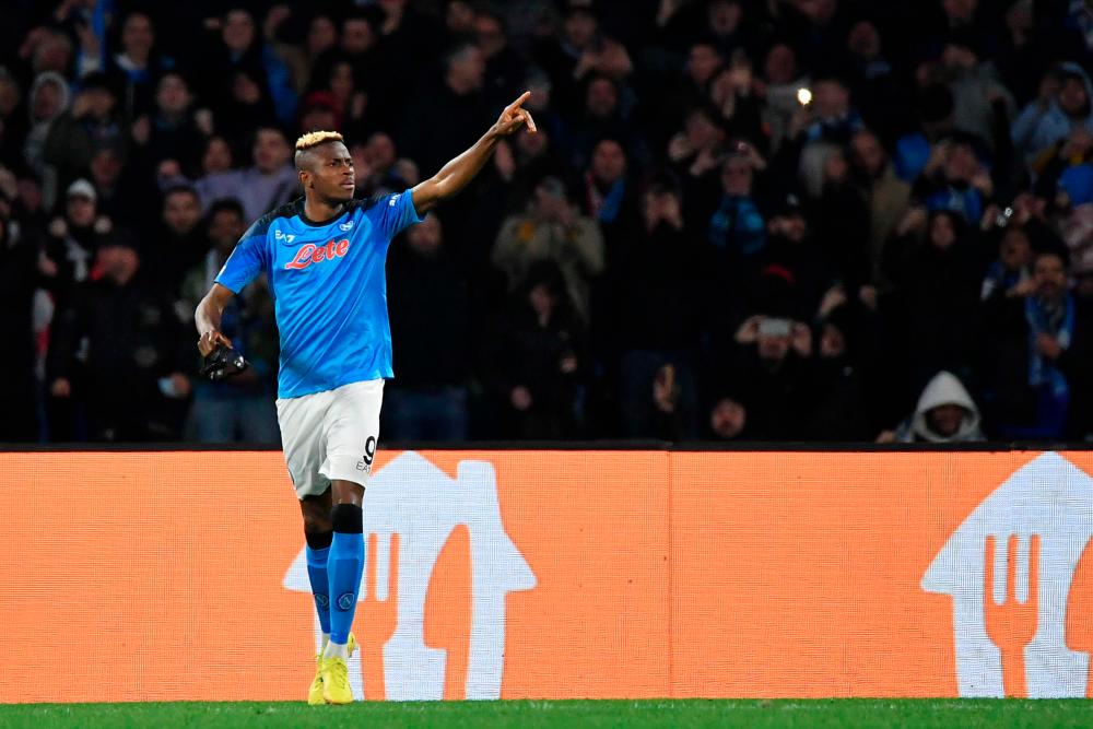 Napoli forward Victor Osimhen celebrates after opening the scoring during the UEFA Champions League round of 16, second leg football match between SSC Napoli and Eintracht Frankfurt at the Diego-Maradona stadium in Naples on March 15, 2023. AFPPIX